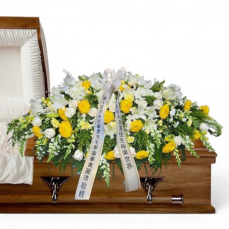 Yellow and white casket spray