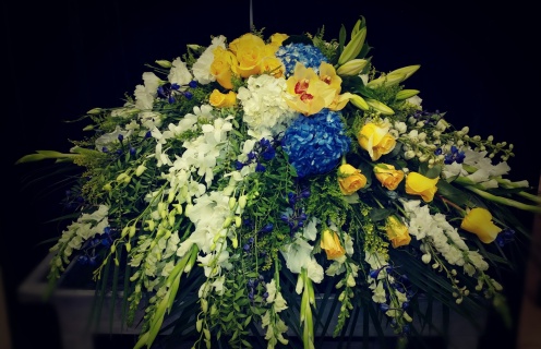 Blues and yellows casket spray